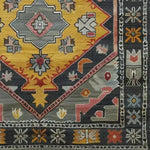 A detailed view of the Petals in Motion Hand Knotted Area Rug showcasing intricate geometric and floral patterns in vibrant colors. This vintage rug is perfect for adding a Persian touch to living room area rugs.
