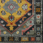 A detailed view of the Petals in Motion Hand Knotted Area Rug showcasing intricate geometric and floral patterns in vibrant colors. This vintage rug is perfect for adding a Persian touch to living room area rugs.