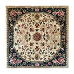 A beautifully detailed, hand-knotted area rug featuring a floral design in earthy tones. This square area rug is perfect for adding elegance to a dining room or bedroom. The intricate Persian-inspired pattern makes it an ideal choice for those seeking a luxurious wool rug to complement their dining table or living space.