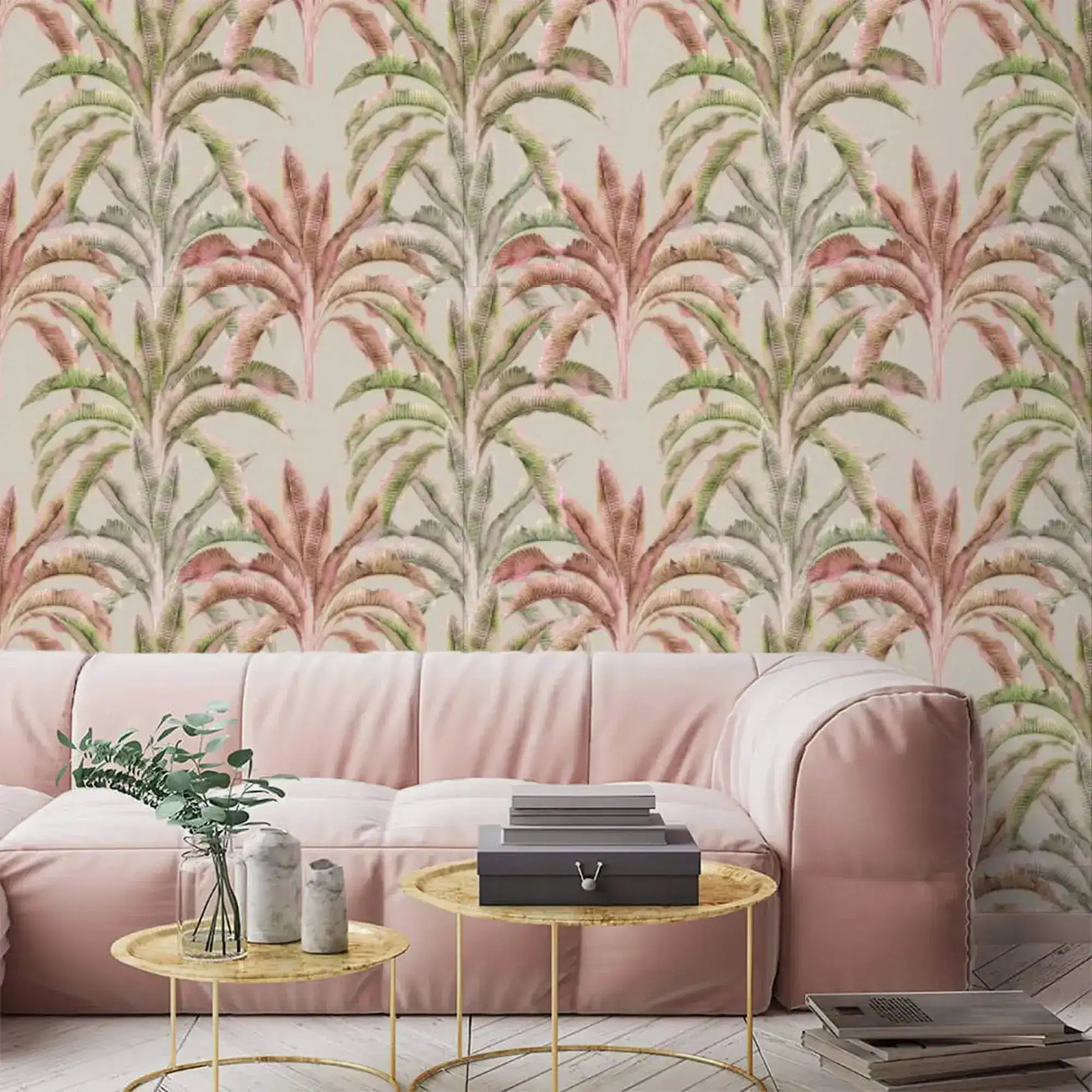 Pink and green banana grove wallpaper above a blush sofa with gold coffee tables in a living room