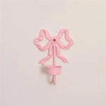Pink Bow Wall Candlestick Holder cast metal bow-shaped wall-mount with small candle cup front view