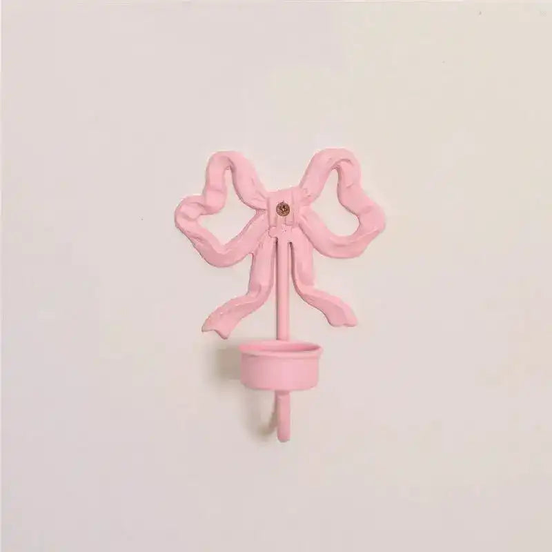 Pink Bow Wall Candlestick Holder cast metal bow-shaped wall-mount with small candle cup front view