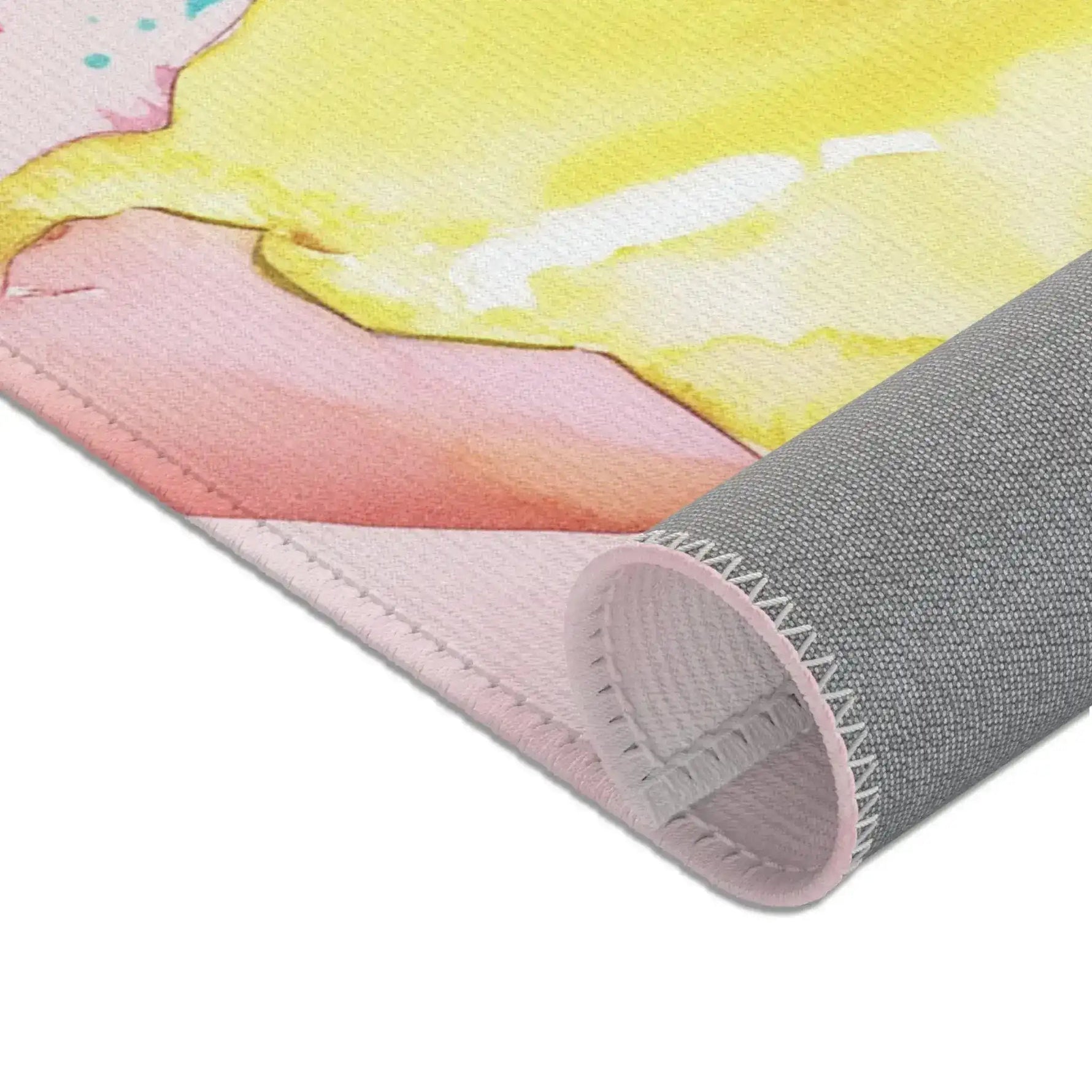Pink Donut Drip Accent Rug corner folded back revealing gray non-slip backing and sewn hem construction detail