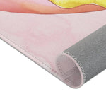 Pink Donut Drip Accent Rug lower corner pink watercolor base with yellow drip and rolled gray backing side view