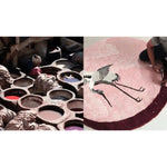 Artisan hand-tufting a round wool rug with pink flying Japanese cranes design. Perfect large area rug for bedroom or living room, adding elegance and warmth.