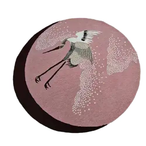 This is a beautifully crafted hand-tufted round area rug featuring elegant Japanese cranes in flight on a soft pink background. Perfect for adding a touch of sophistication to your bedroom or living room, this wool rug combines artful design with comfort. Ideal as a large area rug for bedrooms or living rooms.