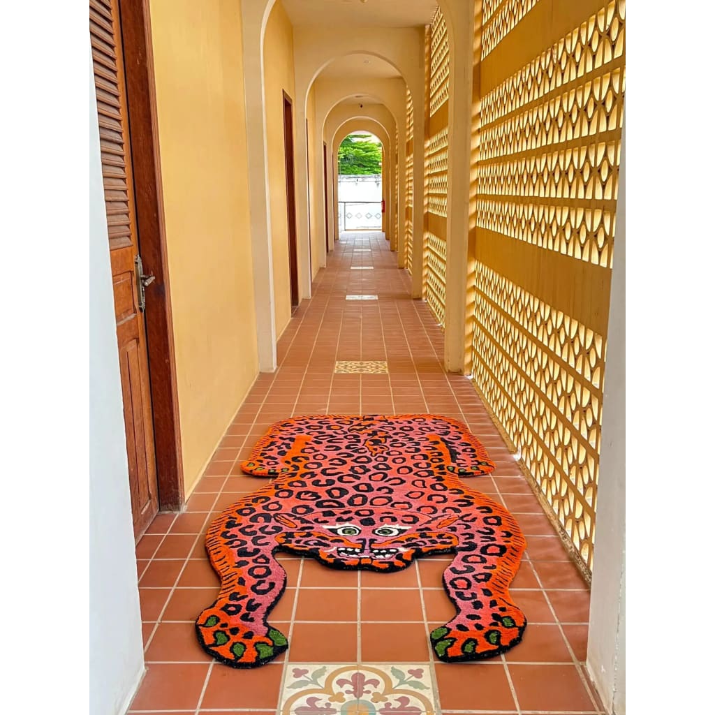 A vibrant Pink Leopard Yogi Accent Wool Rug in a hallway, showcasing its unique leopard design. This large area rug is perfect for adding a bold touch to living rooms, with its striking colors and vintage appeal. Ideal for those seeking living room rugs 8x10 and wool rugs with personality and style.