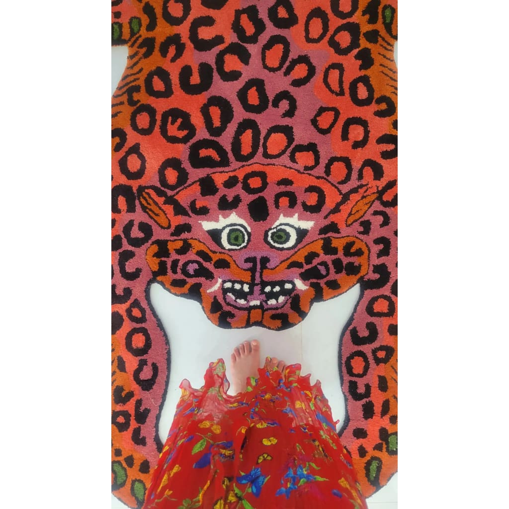 A vibrant Pink Leopard Yogi Accent Wool Rug, showcasing a bold leopard design in rich pink and orange hues. Perfect for adding a splash of color to your living room, this large area rug combines vintage charm with modern flair, fitting comfortably in an 8x10 space. Ideal for those seeking unique and lively rugs for their living room.