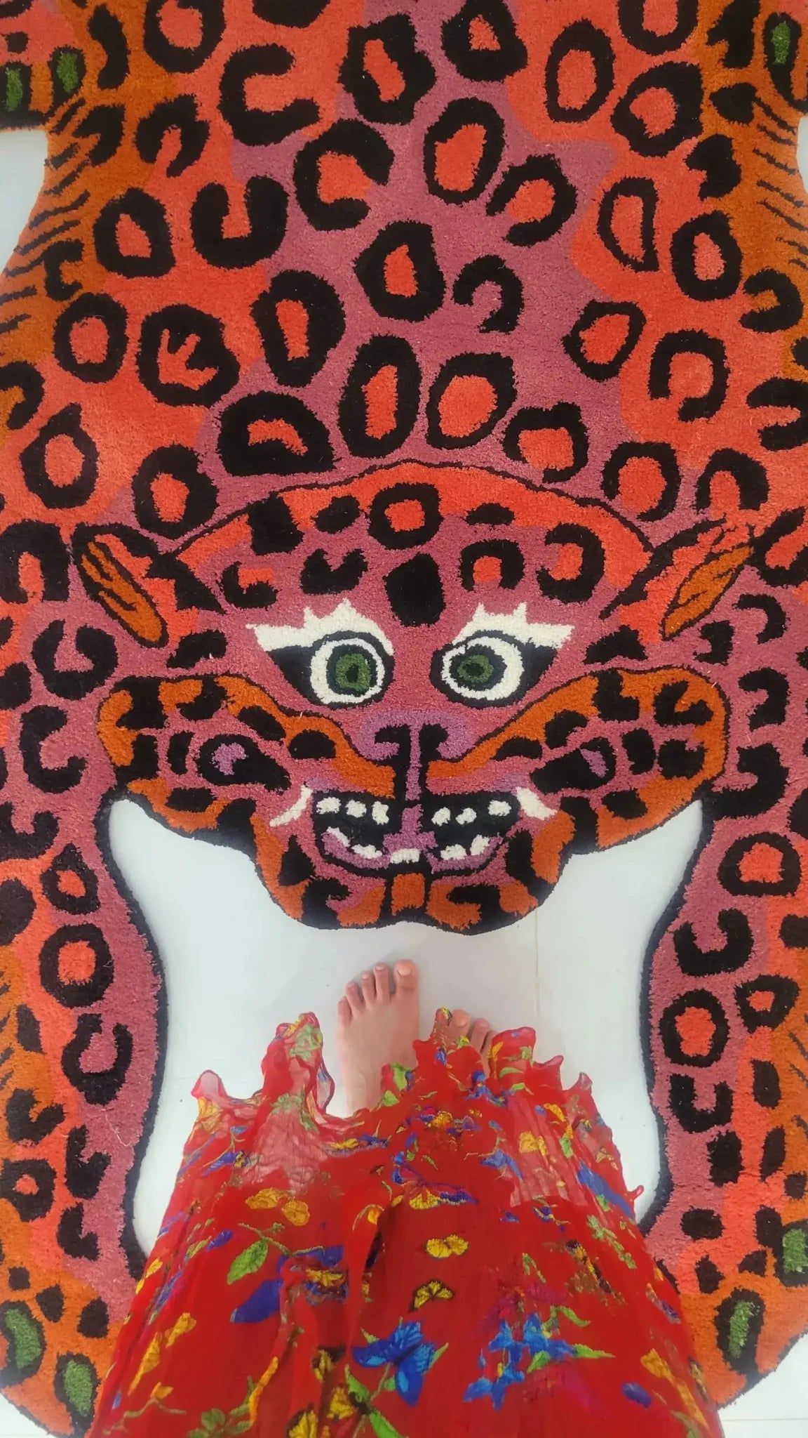 A vibrant Pink Leopard Yogi Accent Wool Rug, showcasing a bold leopard design in rich pink and orange hues. Perfect for adding a splash of color to your living room, this large area rug combines vintage charm with modern flair, fitting comfortably in an 8x10 space. Ideal for those seeking unique and lively rugs for their living room.