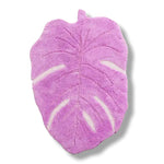 A vibrant pink Monstera leaf shaped area rug crafted from hand-tufted wool, perfect for adding a playful touch to your living room. This unique wool rug stands out as a statement piece, ideal for living room rugs 8x10.