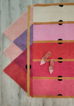 Top view of a Pink Prism Geometric Hand-Tufted Wool Rug in a contemporary design, ideal for living room area rugs. The vibrant colors and bold patterns make it a standout contemporary rug, adding a touch of vintage charm to any living room. Perfect as a wool rug, this piece offers both style and comfort, making it an excellent choice for area rugs for living room spaces.