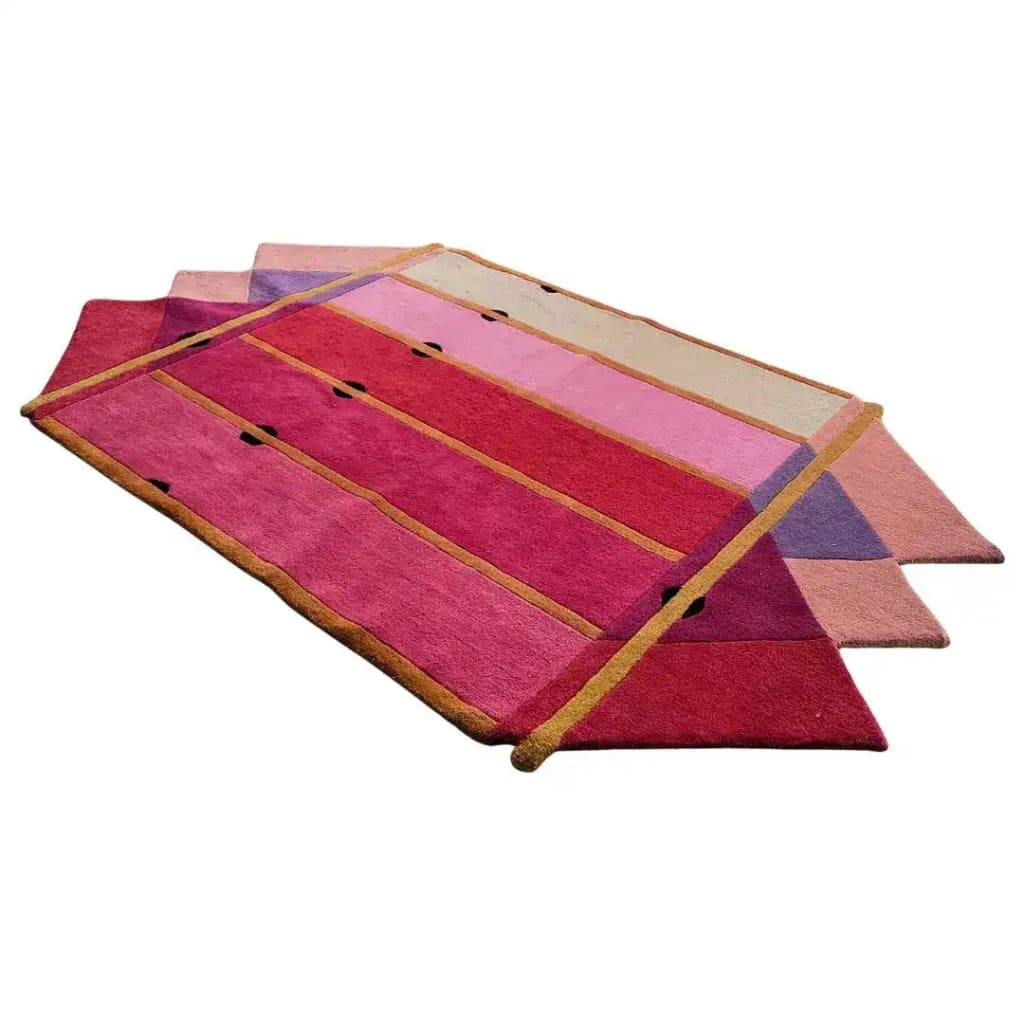 A vibrant Pink Prism Geometric Hand-Tufted Wool Rug featuring a striking design with bold pink and purple hues. This contemporary rug is perfect for adding a touch of elegance to any living room, blending modern aesthetics with a vintage charm. Ideal for those seeking stylish area rugs for living room spaces, this wool rug showcases a unique geometric pattern that stands out beautifully.