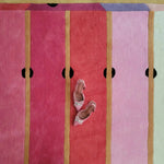 A vibrant Pink Prism Geometric Hand-Tufted Wool Rug displayed with a pair of stylish pink shoes on top. This contemporary rug features bold, colorful stripes, perfect for adding a modern touch to any living room. Ideal for those seeking unique area rugs for living room spaces, this wool rug combines vintage charm with contemporary design.