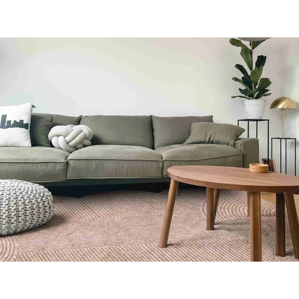 A cozy living room setup featuring a Pink Scallop Arch Geometric Hand Tufted Wool Rug, perfect as an area rug for both dining room carpets and living room and dining room rugs. The elegant wool rug adds warmth and style to the space, complementing the comfortable green sofa, round wooden coffee table, and lush indoor plant.