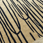 Close-up view of a Pink Scalloped Contemporary Art Hand Tufted Area Rug, featuring a striking abstract pattern with deep black lines against a beige backdrop. This wool rug is perfectly designed for living room spaces, especially as an area rug in an 8x10 size.