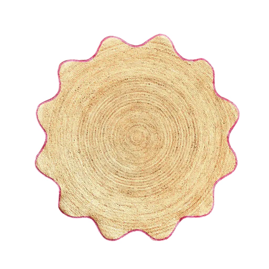 Top view of a natural round jute rug with a pink trim, perfect for adding a touch of elegance to dining rooms or living areas. This area rug features a unique scalloped edge design, making it an ideal choice for those seeking stylish living room area rugs or round rugs for cozy spaces.