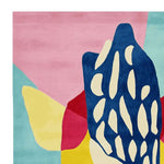 Vibrant and colorful area rug featuring an abstract pattern with bold shapes in pink, blue, yellow, and red hues. This contemporary wool rug is perfect for adding a playful touch to large living rooms and offers a unique design made from high-quality materials.