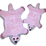 Charming polar bear shaped tufted wool rugs in pink, ideal as area rugs for a cozy living room or under a dining table. These playful wool rugs add a touch of whimsy to any dining room or living room space.