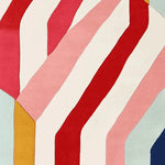 Vibrant and contemporary area rug featuring bold, colorful stripes in red, pink, and white. This wool rug is perfect for adding a modern touch to living room area rugs with its playful design.