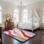 Neatly decorated bedroom with a colorful rug on the floor.