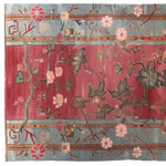 The Poppy Serenade Knotted Wool Rug showcases a vibrant floral design with intricate patterns. This area rug, perfect for any living room, features a mix of red and blue tones, adorned with delicate flowers and leaves. Ideal for those seeking a floral rug, it fits beautifully as a living room rug in an 8x10 size, making it a stunning addition to any large living room.