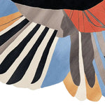 A close-up view of a vibrant and contemporary hand-tufted wool area rug, featuring bold abstract patterns with black, white, orange, and blue hues. Perfect for adding a modern touch to living room spaces, especially suitable for 8x10 layouts.