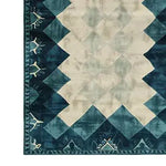 Close-up view of the Prism Tides Hand Tufted Wool Rug, showcasing its contemporary design with geometric patterns in shades of blue and cream. Perfect for adding a touch of elegance to living rooms or offices, this area rug is crafted from high-quality wool, making it a luxurious and durable choice for any space.