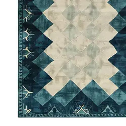Close-up view of the Prism Tides Hand Tufted Wool Rug, showcasing its contemporary design with geometric patterns in shades of blue and cream. Perfect for adding a touch of elegance to living rooms or offices, this area rug is crafted from high-quality wool, making it a luxurious and durable choice for any space.