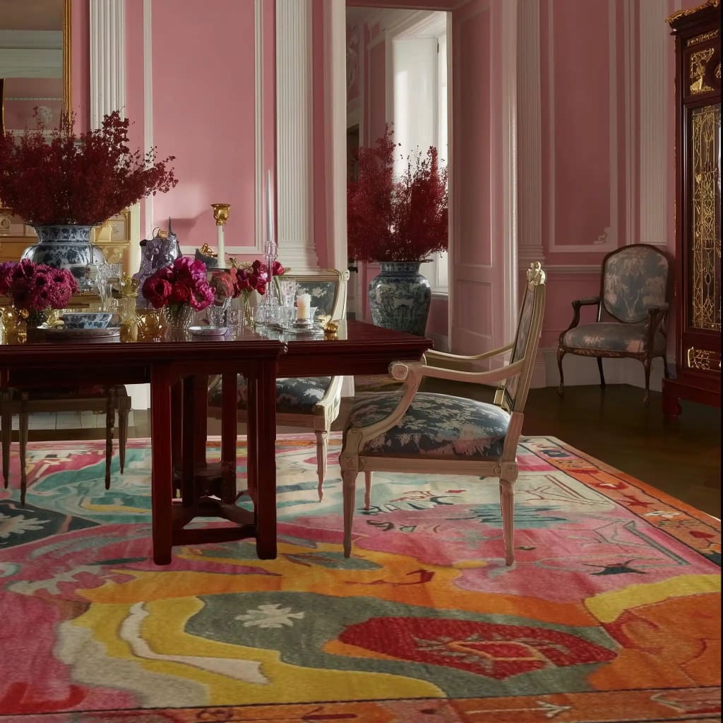 This stunning Prismatic Core Hand Tufted Rug, measuring 8 x 10 ft, is the centerpiece of a luxurious living room. The vibrant, abstract design features a blend of pink, orange, and teal hues, bringing a vintage charm to the space. Perfect for large living rooms, this wool area rug complements the elegant furniture and decor, adding a touch of sophistication to the room.