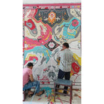 Artisans crafting a Prismatic Core Hand Tufted Rug in vibrant colors, ideal for large living room spaces. This wool rug features a vintage abstract design, perfect as a statement piece in any living room area.