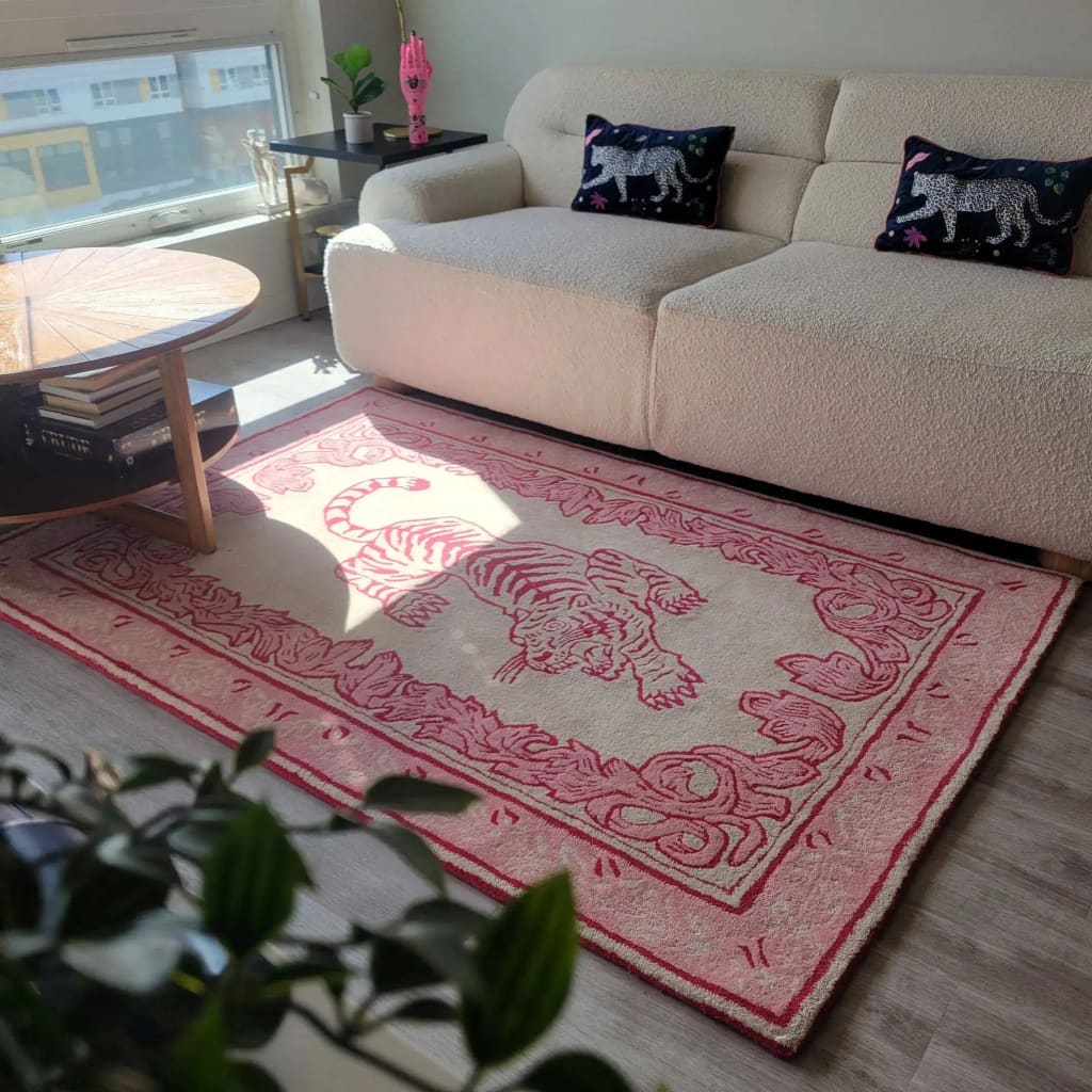 Bright living room featuring the Prowess in Pink Garden Hand-Tufted Area Rug with a bold pink tiger design. This wool rug provides a cozy and stylish touch to the large living room, complementing the modern sofa and chic decor.