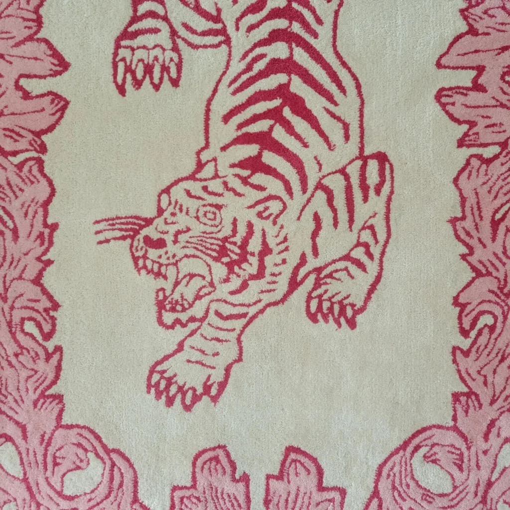 Close-up view of the Prowess in Pink Garden Hand-Tufted Rug showcasing an intricate red tiger design on a cream wool background. Perfect for adding a bold statement to a living room, this area rug blends artistic flair with luxury, ideal for large living room spaces.
