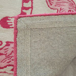 Close-up of the Prowess in Pink Garden Hand-Tufted Area Rug, showcasing its wool texture and vibrant pink patterns. Perfect for adding warmth and style to your living room, this large living room rug features durable craftsmanship and intricate design.