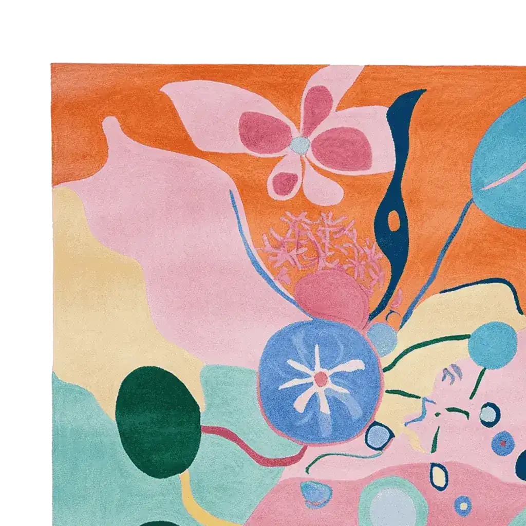 Vibrant and artistic hand tufted area rug featuring a psychedelic garden bloom design. This contemporary wool rug showcases a mix of bold colors like pink, orange, blue, and green, making it a standout piece for large living room spaces.