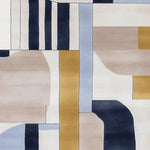Top view of the Pulse Point Grid Hand Tufted Area Rug showcasing a contemporary design with geometric patterns in neutral tones of beige, blue, gold, and black. This wool rug is perfect for adding a modern touch to your living room.
