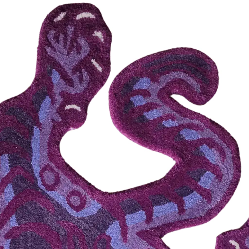A close-up view of a Purple Tibetan Tiger Accent Hand Tufted Wool Rug, showcasing its intricate abstract tiger design. This wool rug is perfect for adding a vintage touch to large living rooms, serving as a standout area rug. Ideal for those seeking unique large area rugs to enhance their living room decor.