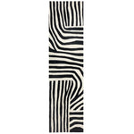 Top view of a contemporary runner rug showcasing a bold, black and white abstract pattern. Perfect for kitchens, hallways, and bathrooms, this hand-tufted wool rug adds a stylish touch to any space.
