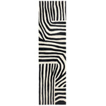 Top view of a contemporary runner rug showcasing a bold, black and white abstract pattern. Perfect for kitchens, hallways, and bathrooms, this hand-tufted wool rug adds a stylish touch to any space.