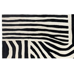 A striking black and white striped wool rug with a zebra pattern, perfect for adding a contemporary touch to any space. This runner rug is ideal for kitchens, hallways, or bathrooms, offering a stylish and durable option for high-traffic areas.