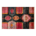 A vibrant area rug featuring an abstract geometric design in shades of red, orange, and pink on a dark background. This wool rug, perfect for adding a stylish touch to living room spaces, is available in an 8x10 size. Its vintage rug pattern brings a unique flair to any decor.