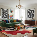 Modern living room with a green sofa, colorful rug, and abstract art.