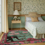 Vibrant and artistic area rug showcasing an elephant and floral design in a cozy bedroom setting. This wool rug adds a touch of elegance and warmth, perfect for large living room rugs and Persian-inspired decor. Ideal for adding character to any living room space.
