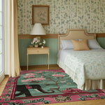 Vibrant and artistic area rug showcasing an elephant and floral design in a cozy bedroom setting. This wool rug adds a touch of elegance and warmth, perfect for large living room rugs and Persian-inspired decor. Ideal for adding character to any living room space.