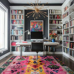A vibrant Radiant Spectrum Wool Hand Knotted Area Rug in a cozy living room setting. This colorful square area rug features an abstract design with pink, yellow, and green hues, adding a pop of color to the modern home office space with bookshelves and a stylish desk, showcasing its versatility as a living room area rug.