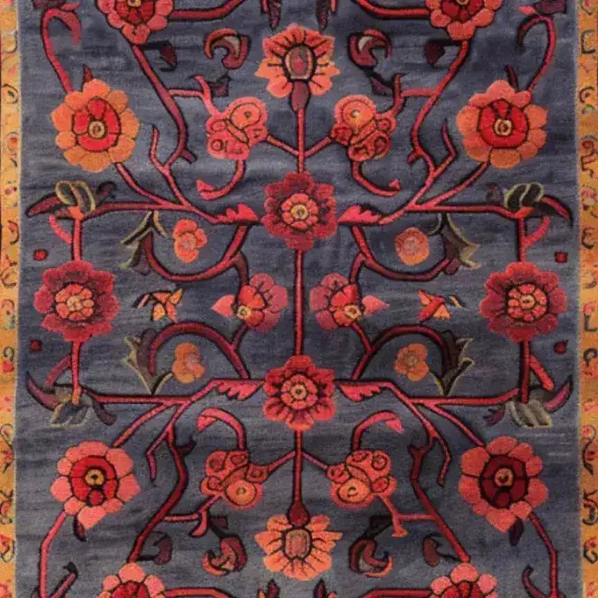 A beautifully intricate Red Bloom Harmony Rug, hand-tufted and perfect for dining room decor. This 8x10 area rug features a striking floral design with red and orange blooms on a rich blue background, embodying a vintage charm. Ideal for adding a warm, inviting touch to your living room or dining area, this wool rug combines elegance and durability.