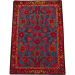 Vibrant Red Bloom Harmony area rug, hand-tufted with intricate floral patterns. Perfect for adding a vintage touch to your dining room or living room. This 8x10 wool rug features rich reds and blues, ideal for those seeking a stylish floral rug.