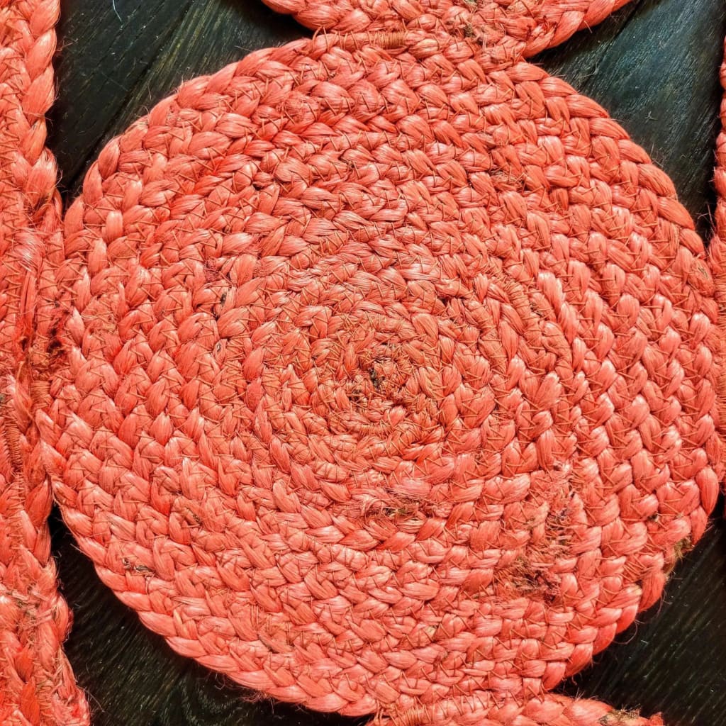 Close-up view of a Red Classic Circles Round Jute Rug, showcasing the intricate braided texture and vibrant red color. Perfect for adding a touch of warmth to living room rugs 8x10 or bedroom area rugs. Ideal for those seeking a stylish round rug for their bedroom or living room.