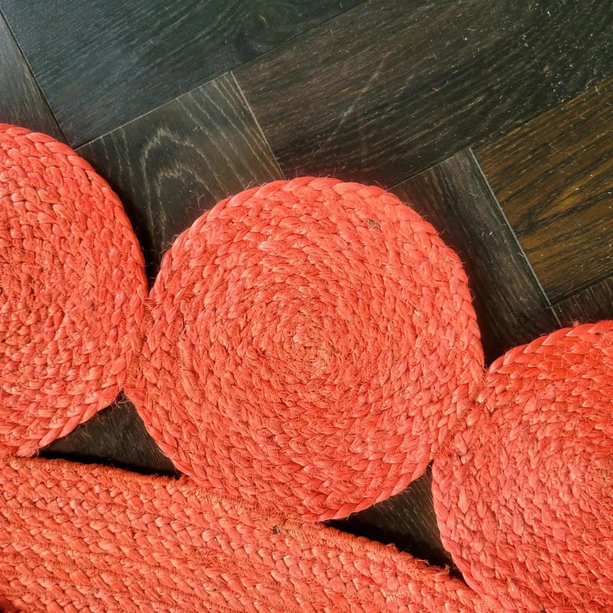 Close-up view of the Red Classic Circles Round Jute Rug, highlighting its intricate woven patterns. This stylish area rug is perfect for enhancing your living room or bedroom with a touch of vibrant color, fitting ideally as a living room rug 8x10 or a bedroom area rug.