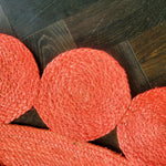 Close-up view of the Red Classic Circles Round Jute Rug, highlighting its intricate woven patterns. This stylish area rug is perfect for enhancing your living room or bedroom with a touch of vibrant color, fitting ideally as a living room rug 8x10 or a bedroom area rug.