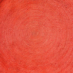 Top view of a vibrant red classic circles round jute rug, perfect for adding a pop of color to your living room or bedroom. This 9' x 9' area rug features a tightly woven texture, ideal for spaces seeking a touch of natural charm, resembling living room rugs 8x10 or bedroom area rugs.
